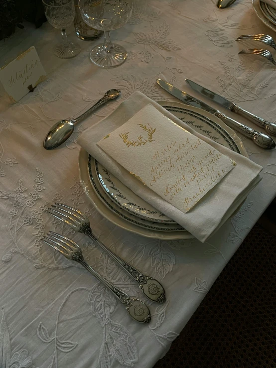 silver and white table with place setting for two people