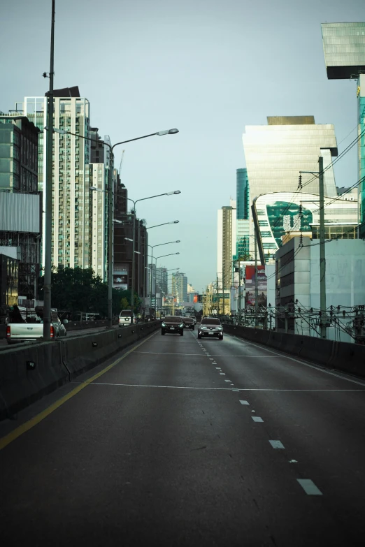 cars going down the road through the city