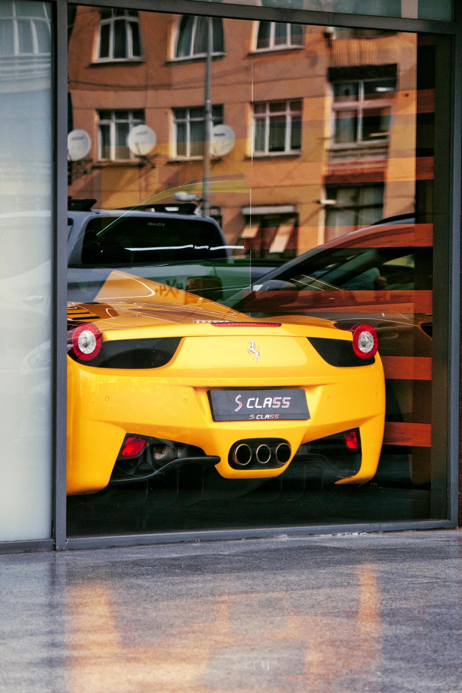 two cars in a garage that are reflected in the glass