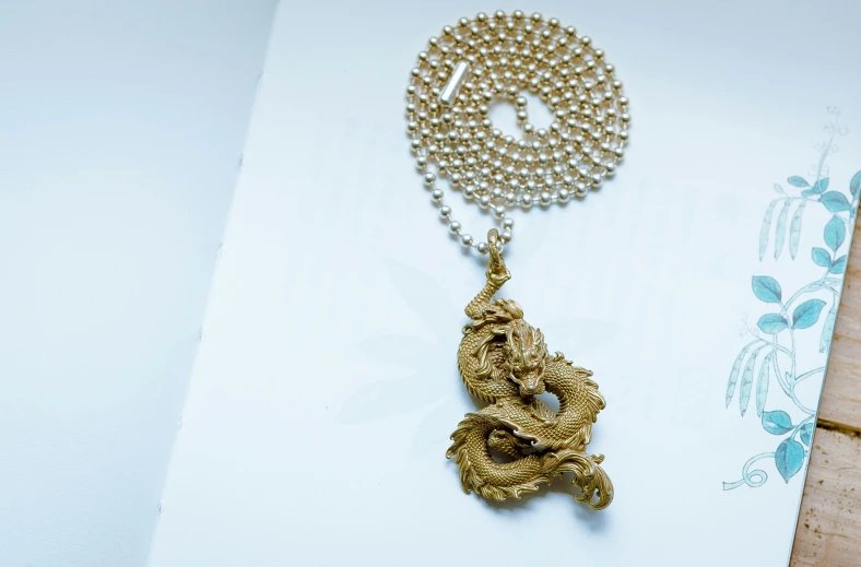 a chain and snake figurine hanging from a chain