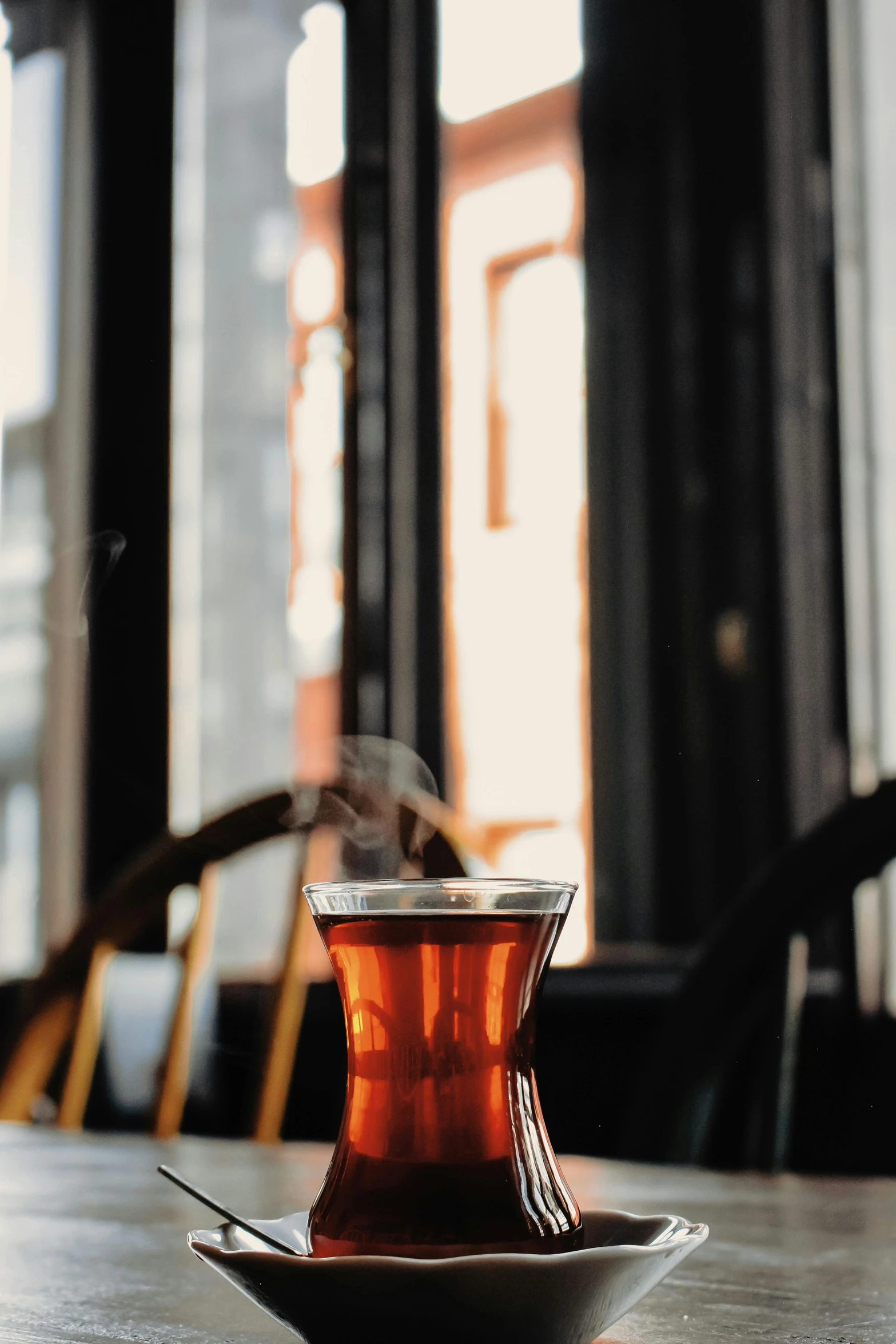 the beverage is in the glass cup on the plate