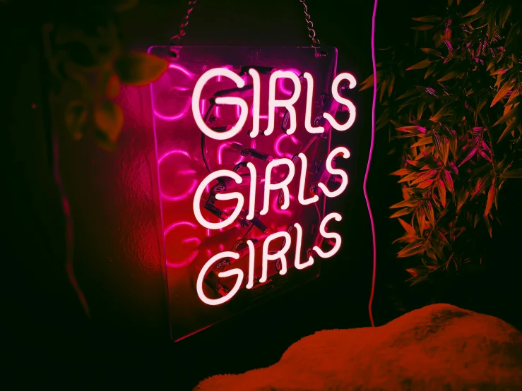 a neon sign that reads girls girls girls