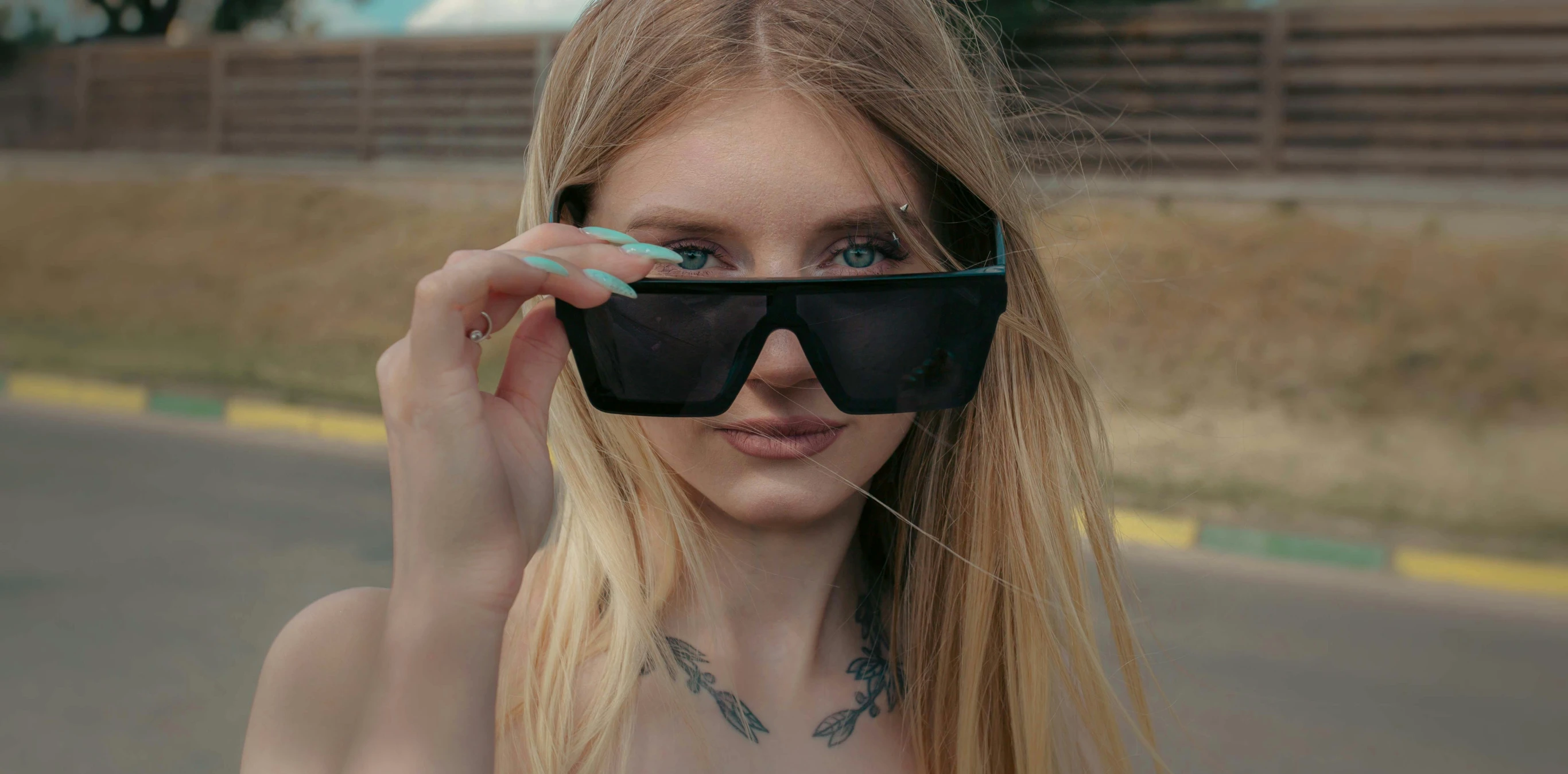 a woman wearing a mask has her sunglasses closed