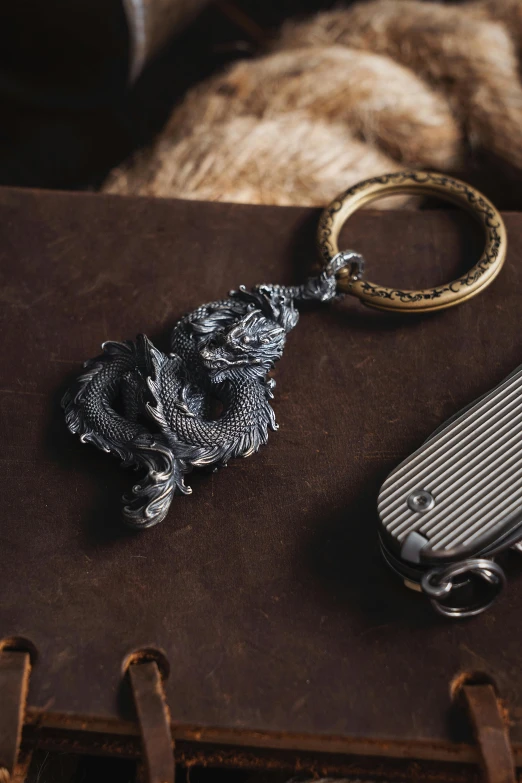 a book with a pen holder and metal keychain sitting on top of it