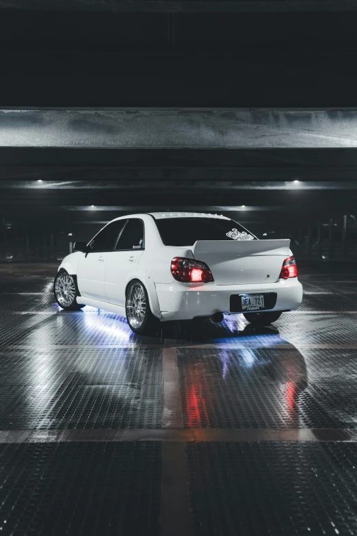 a white car parked in the parking garage