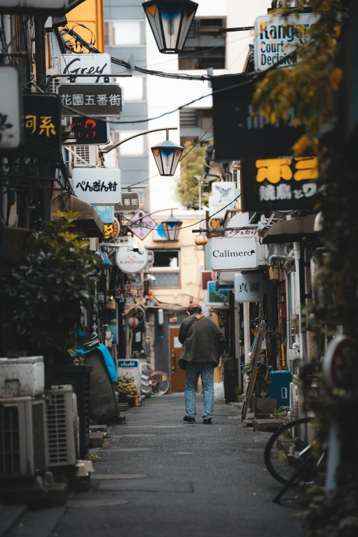 a man walking down the street of an asian town