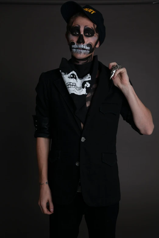 a woman in a black jacket with face paint and a skeleton painted on her face