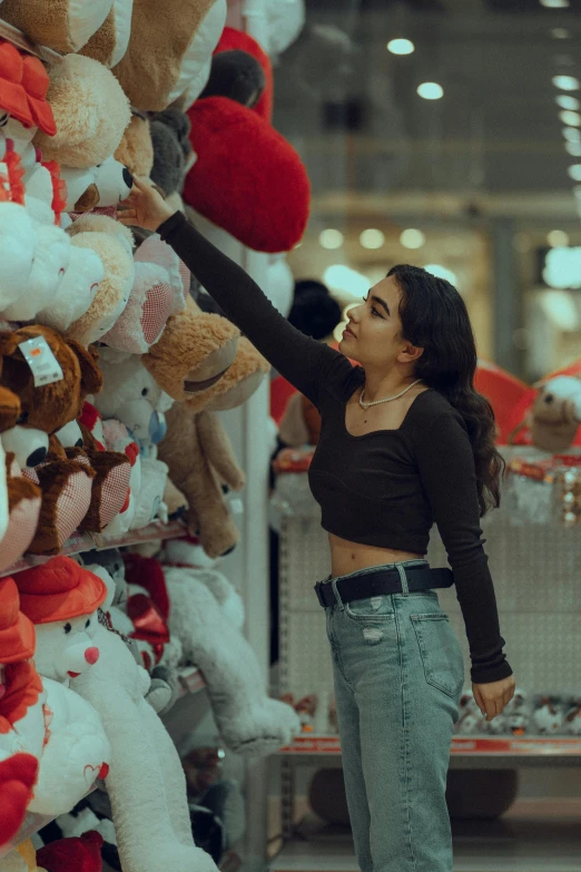 a woman with her arm in the air next to stuffed animals