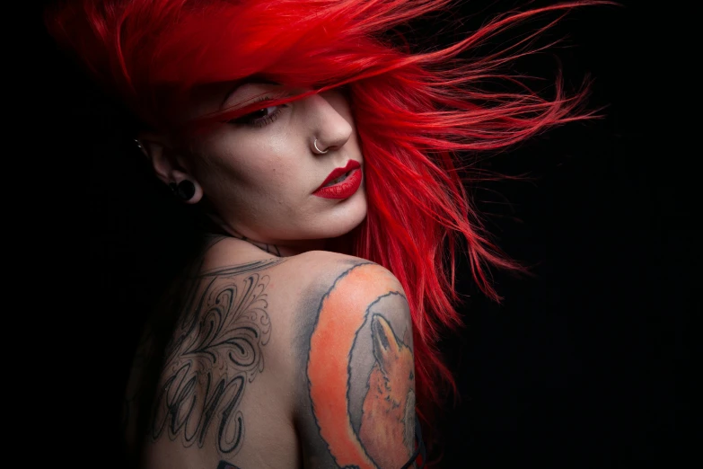 woman with red hair and piercings with tattoos