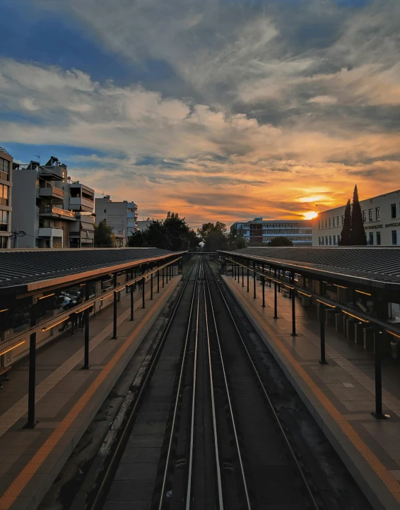 the view from the top of a bridge of a train yard