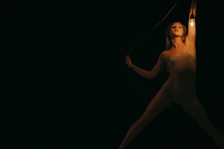 a woman holding onto a string as she runs