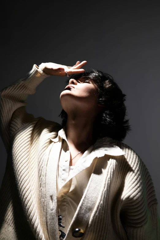 a woman standing in front of a white wall