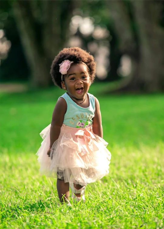 an adorable little girl standing in the grass