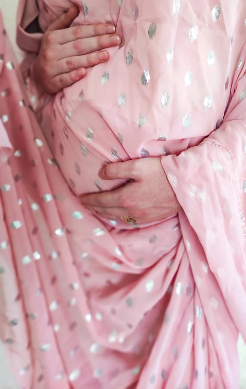 pregnant woman in a pink dress with polka dots