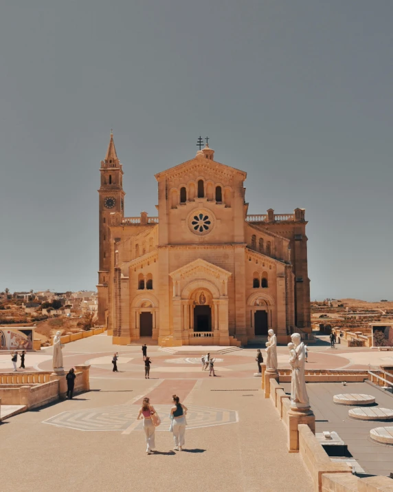 some people are walking around outside a large church