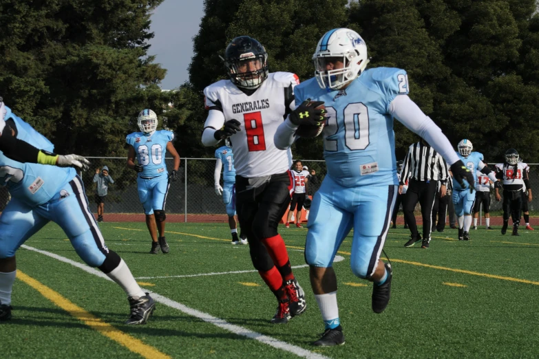 two football players are running for the ball