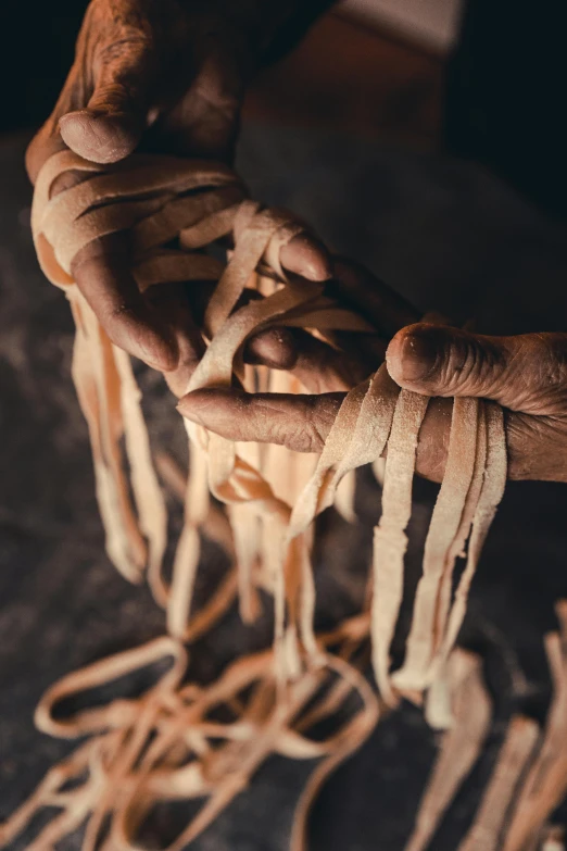 the person is holding strings for making a doll house