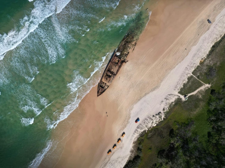 the beach is empty with several boats and horses on it