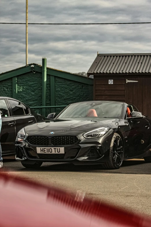 black sports car sits on the side of a road