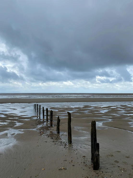 stormy skies and sky above the ocean with beach fence