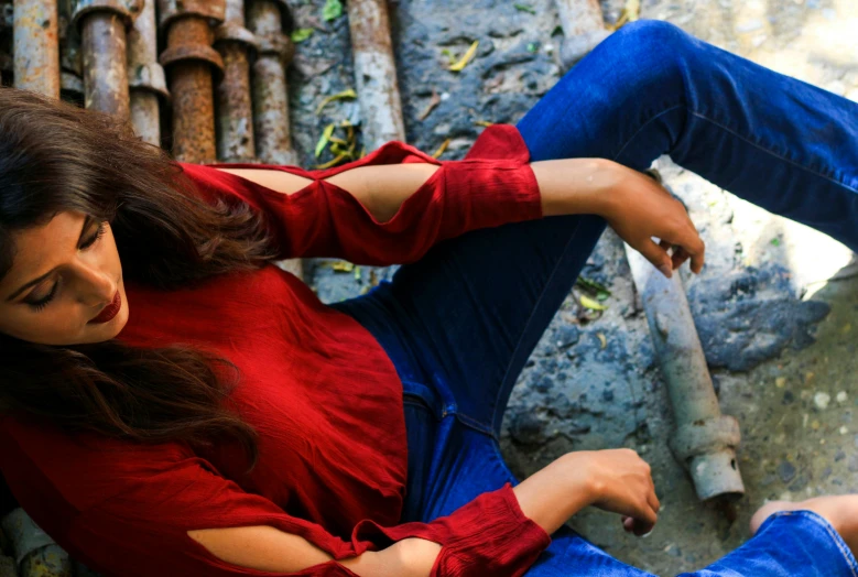 a woman sitting on the ground with her feet crossed