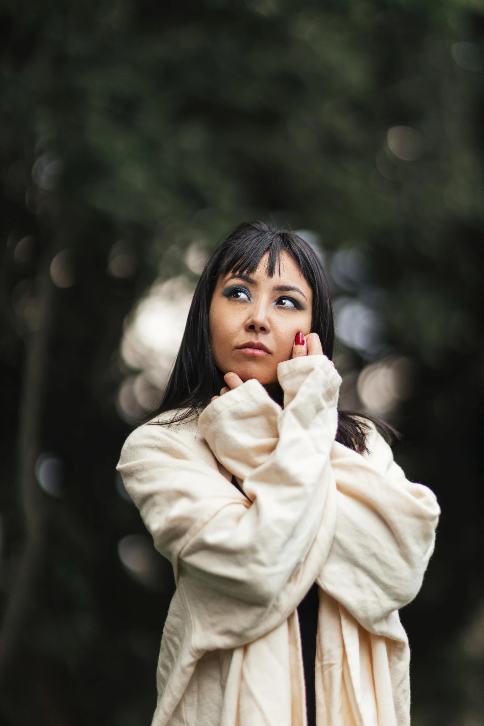 a beautiful young lady with her hands folded up to the side