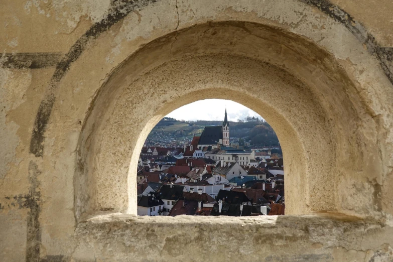 a stone arch with a clock tower in the middle of it