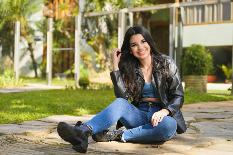 a woman sits on a path with her hair in pigtails