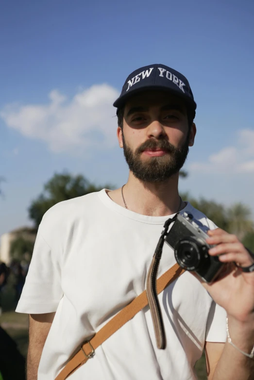 the young man with the beard is taking pictures