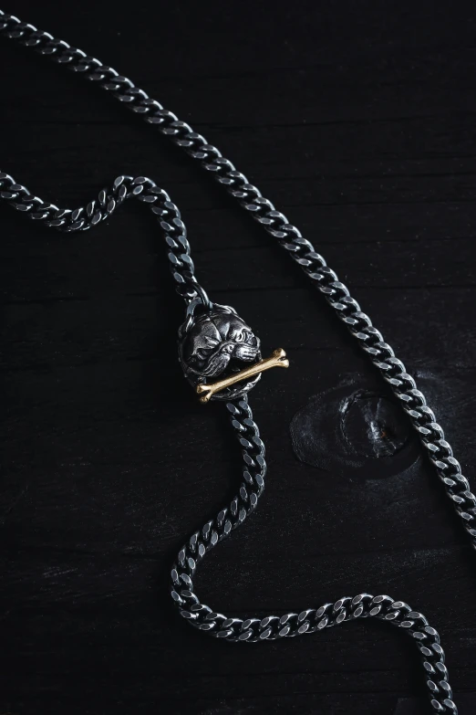 a necklace on a table with some kind of bead attached