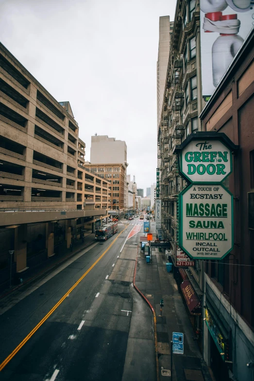 a street with various signage at the end