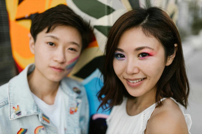 two girls with rainbow makeup and colorful eye shadow