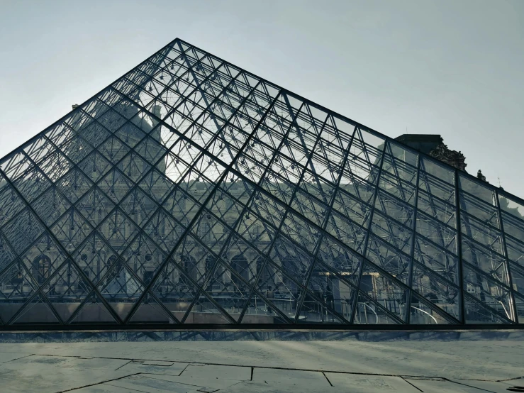 a pyramid with a large glass door on top of it