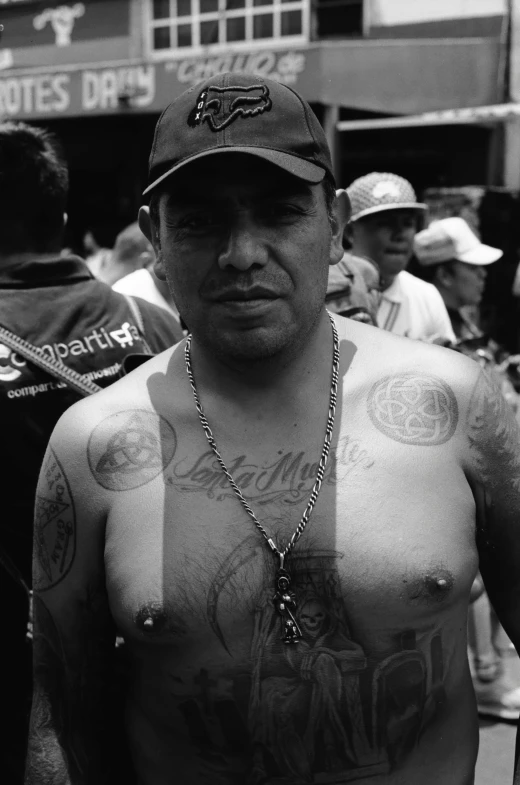 black and white po of man with multiple tattoos and  on
