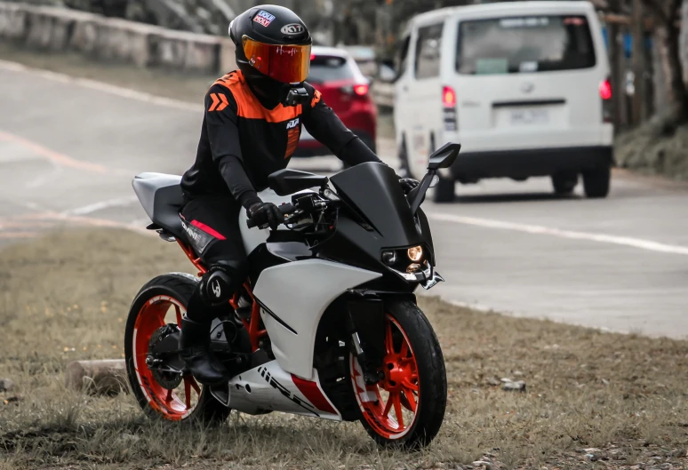 a man is riding on a motorcycle near the road