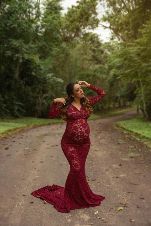 woman in red dress posing on path outdoors