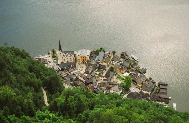 small village sitting on top of a mountain overlooking the water