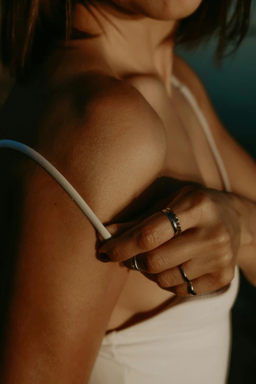 a woman holding onto a ring next to her arm