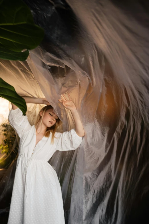 there is a woman wearing white dress and covering her head