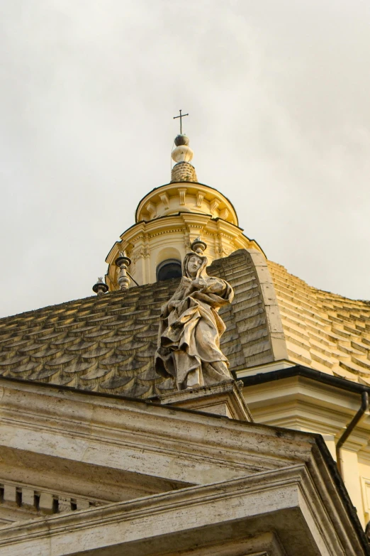 a statue on top of a building with a dome