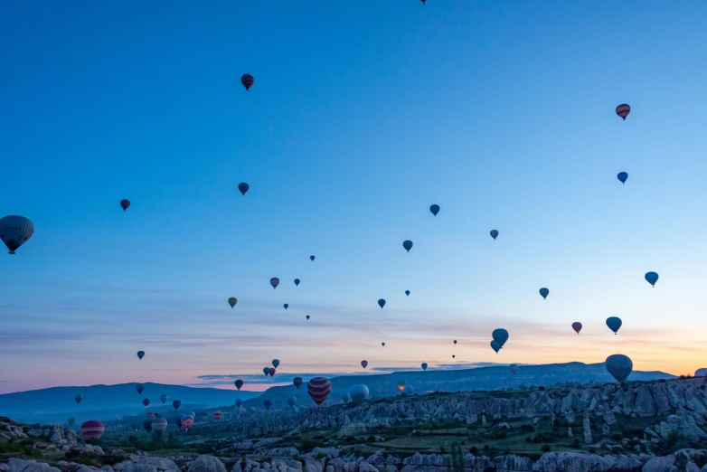 many balloons flying in the sky at night