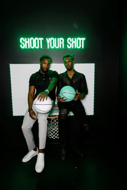 two men posing in front of the camera with their basketballs