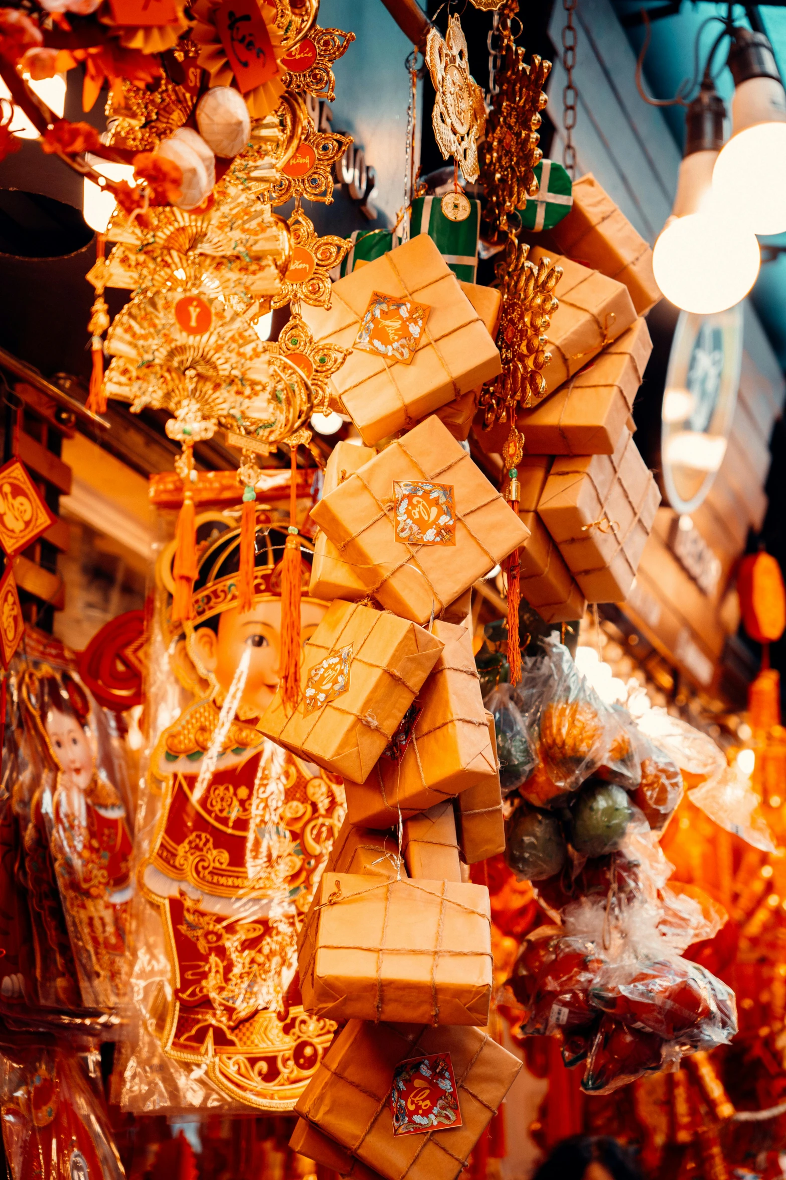 gold necklaces hang on a market stall, some are made from wood