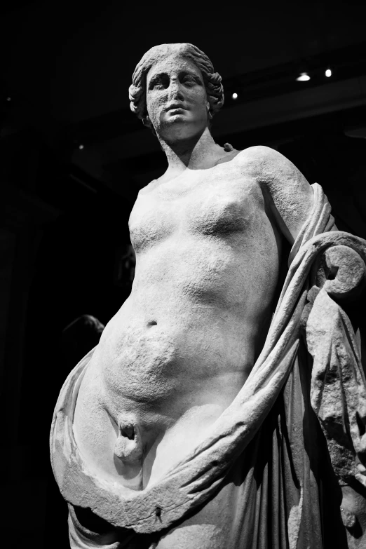 a statue in black and white of a woman holding a towel