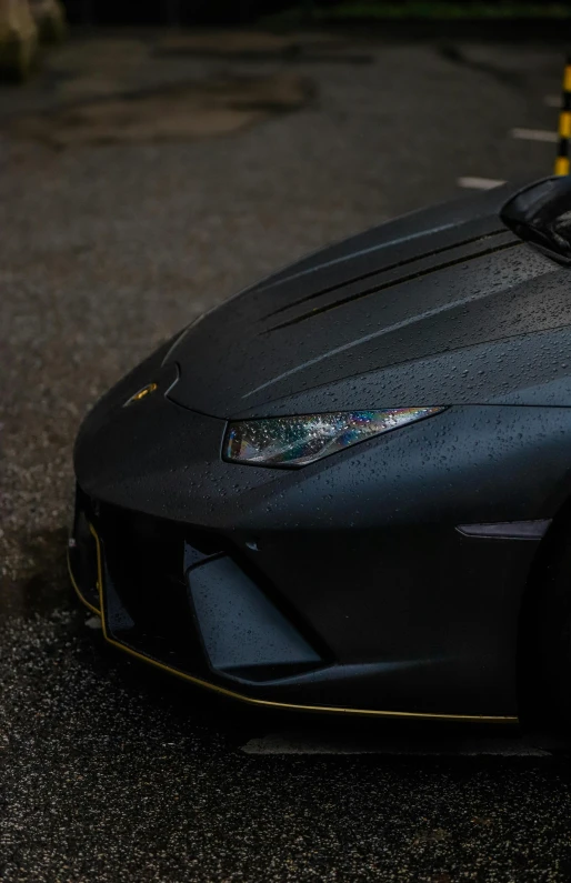 a black sports car sits in the parking lot