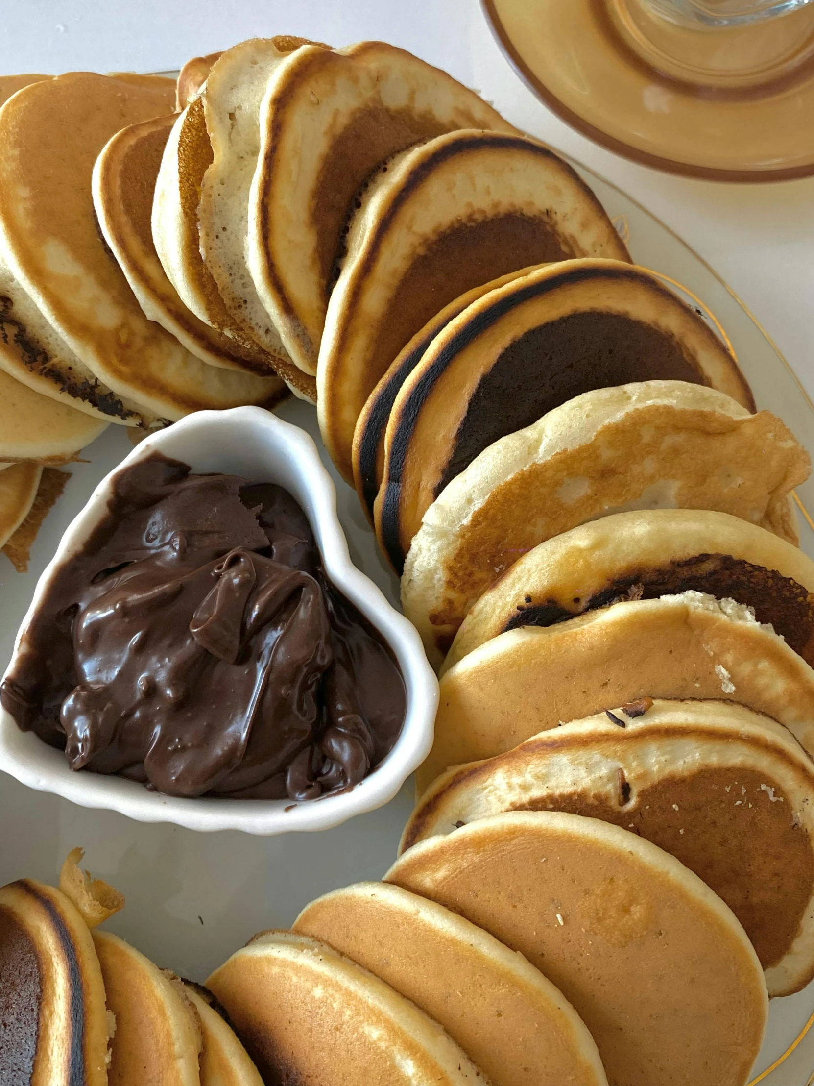 pancake with chocolate filling in front of them on a plate