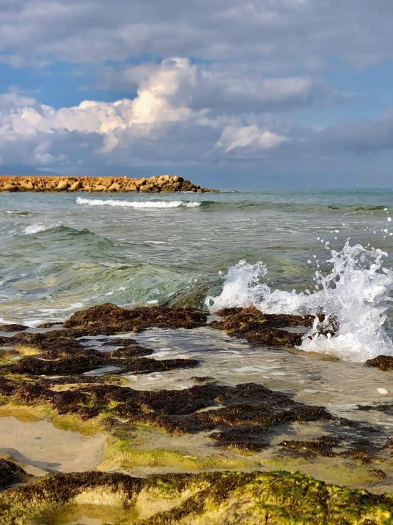 there is water crashing from the rock out of the shore