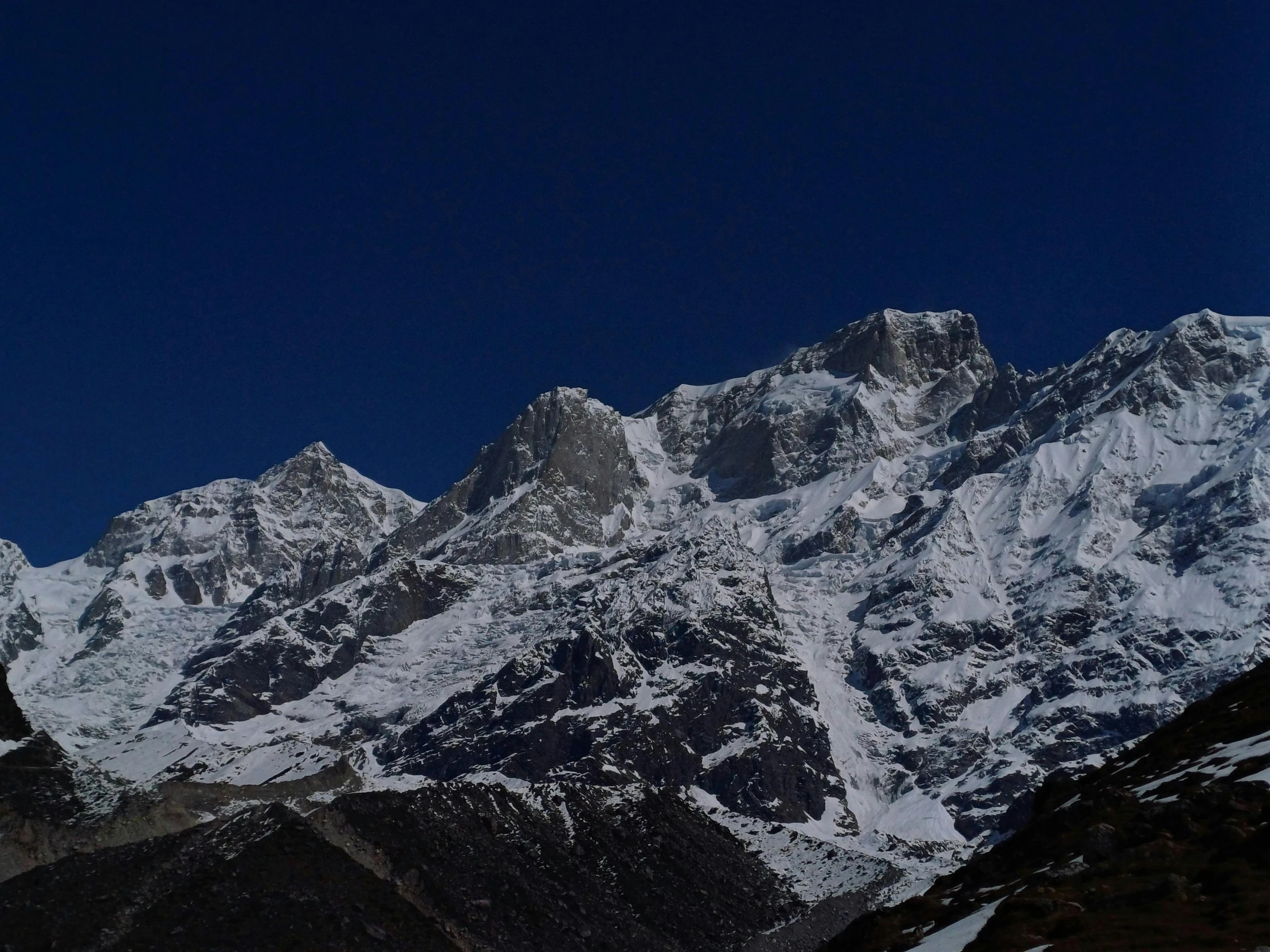 snow capped mountains in the background under a dark sky