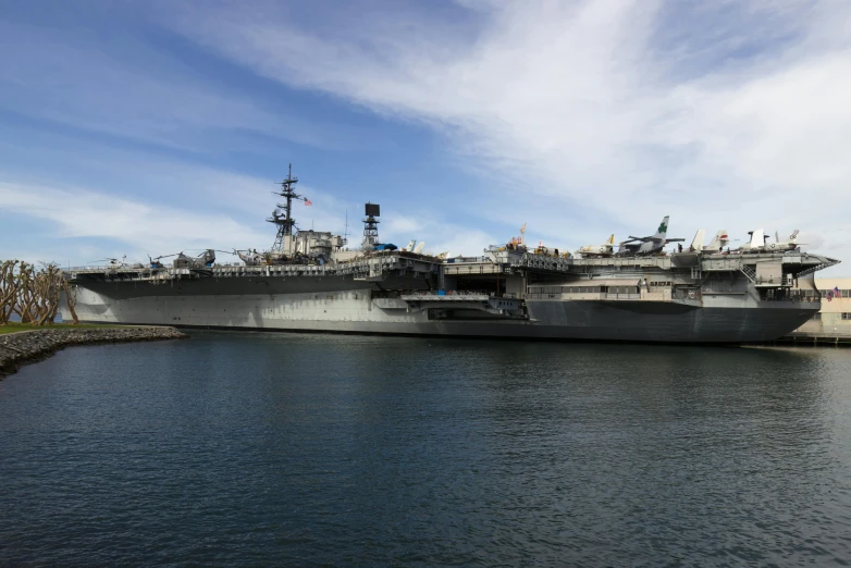 the large ship is docked on the water