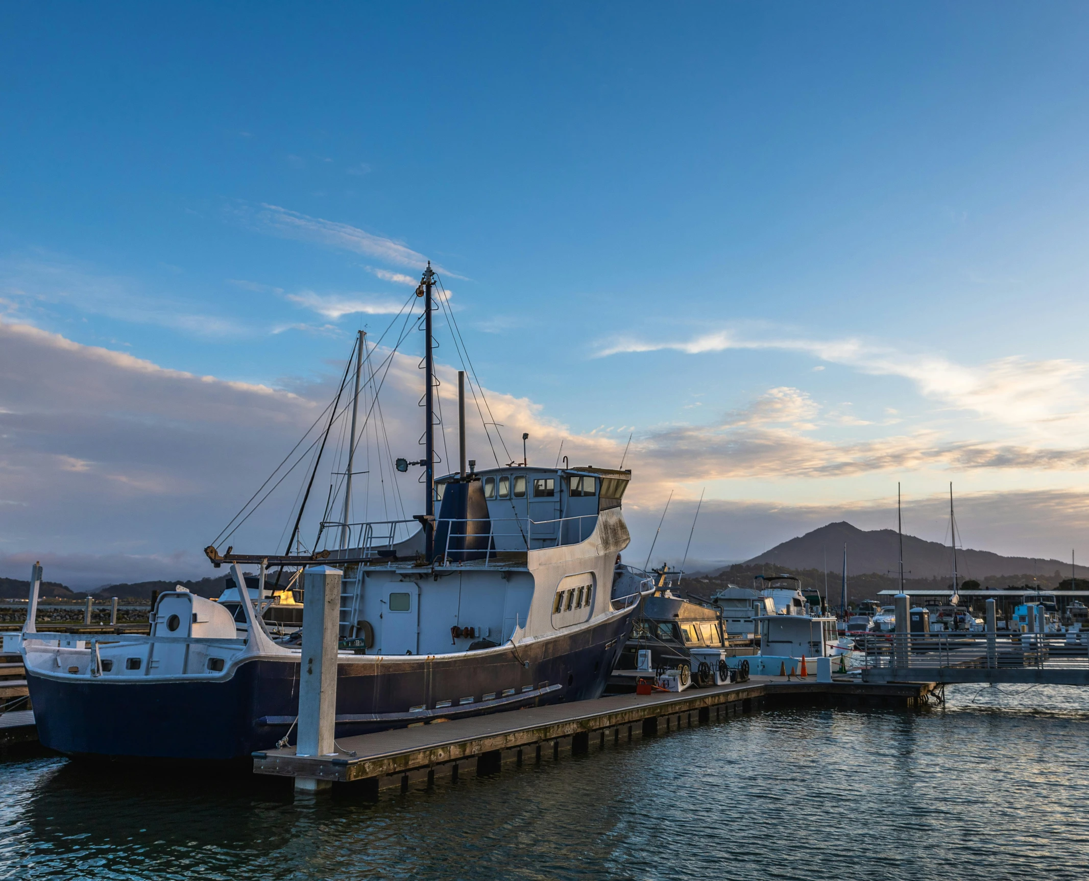 a small tug boat moored at a pier